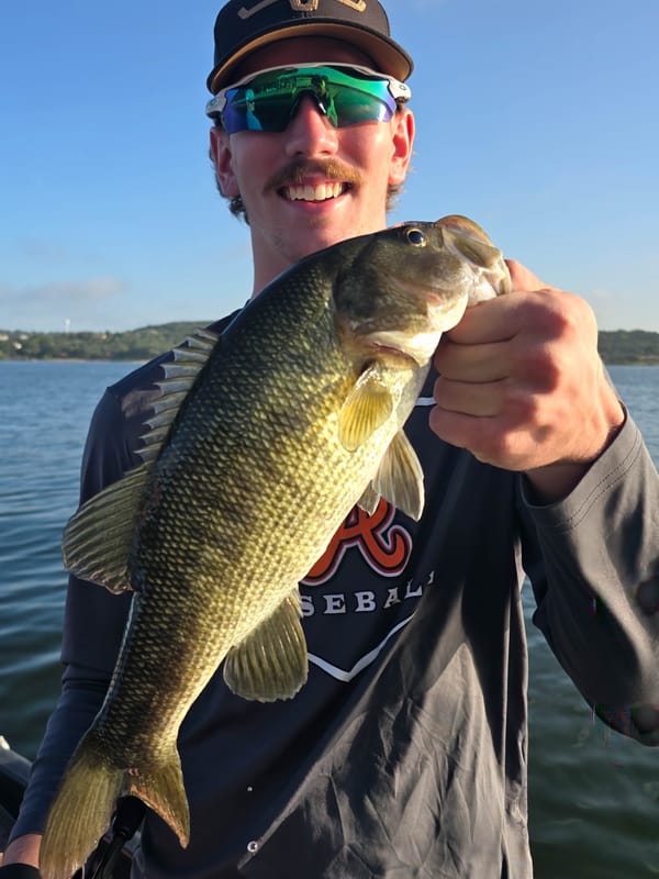 Angler with a fat Guadalupe bass caught on a Texas-rigged worm in 20 feet of water on Lake Travis