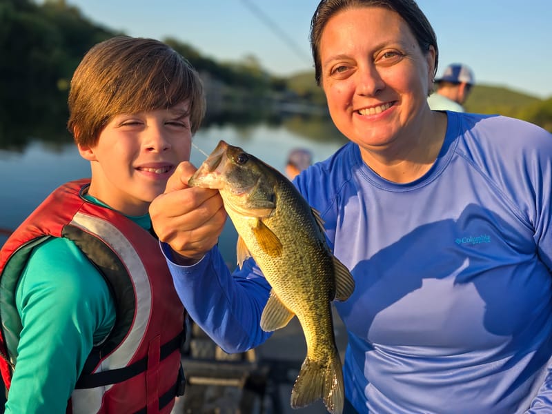 Mom and son with a largemouth bass on a family guided fishing trip on Lake Austin