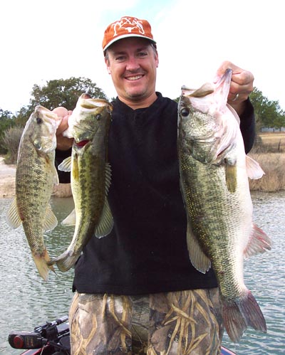 Angler with three Lake Travis largemouth bass in December 2004